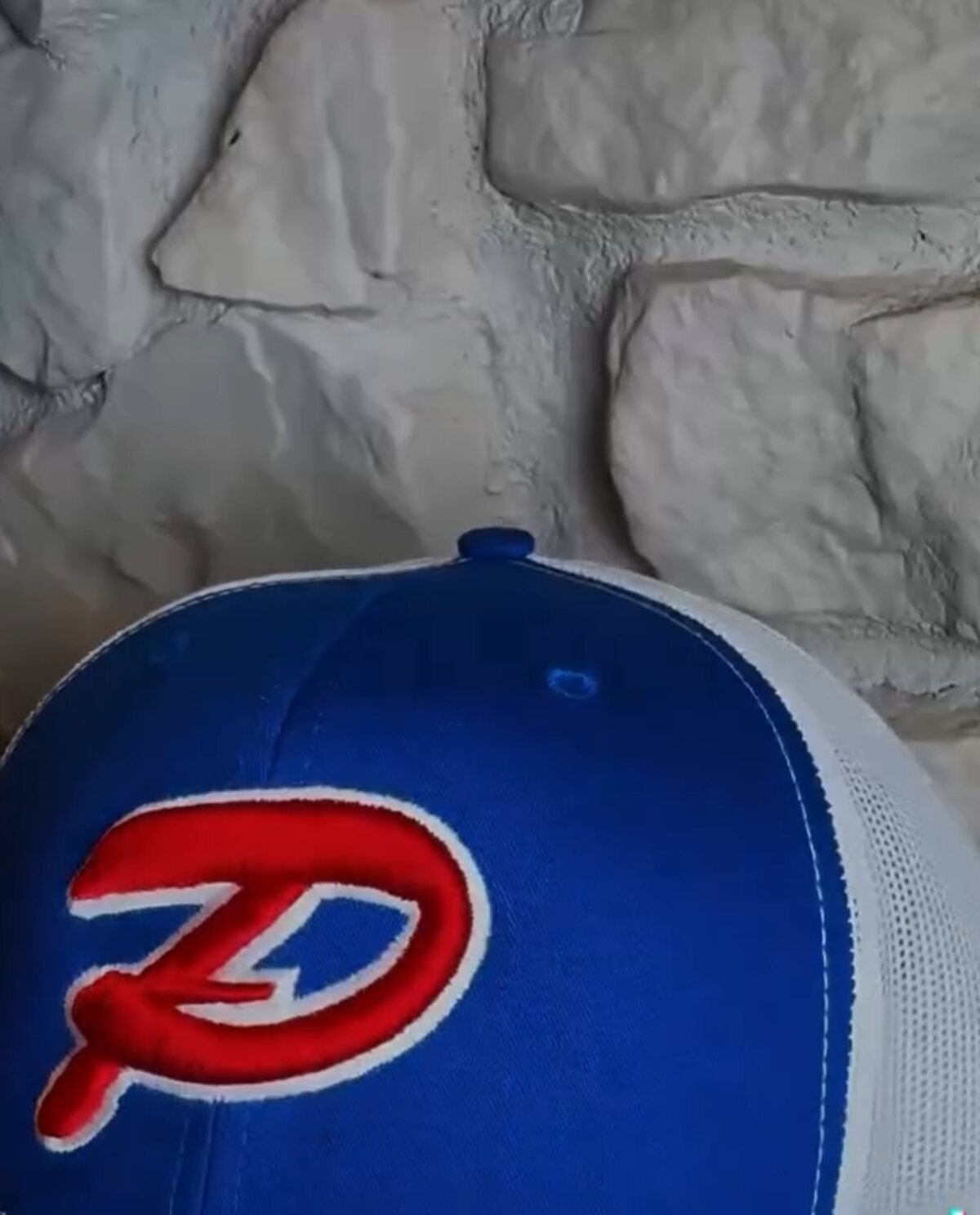 Royal blue trucker cap with a red and white embroidered P monogram